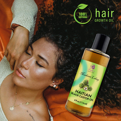 Woman with curly hair and a bottle of Doyley's Haitian Black Castor Oil on the side.